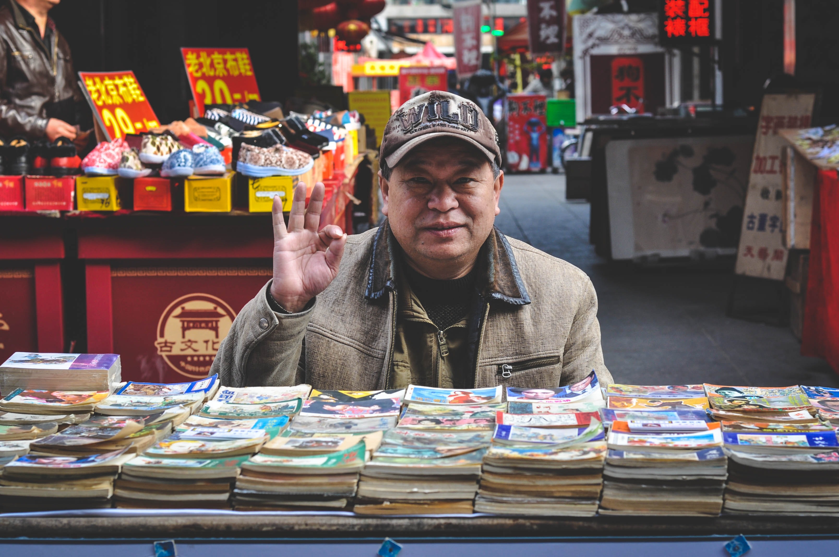 chinese man in front of market stall